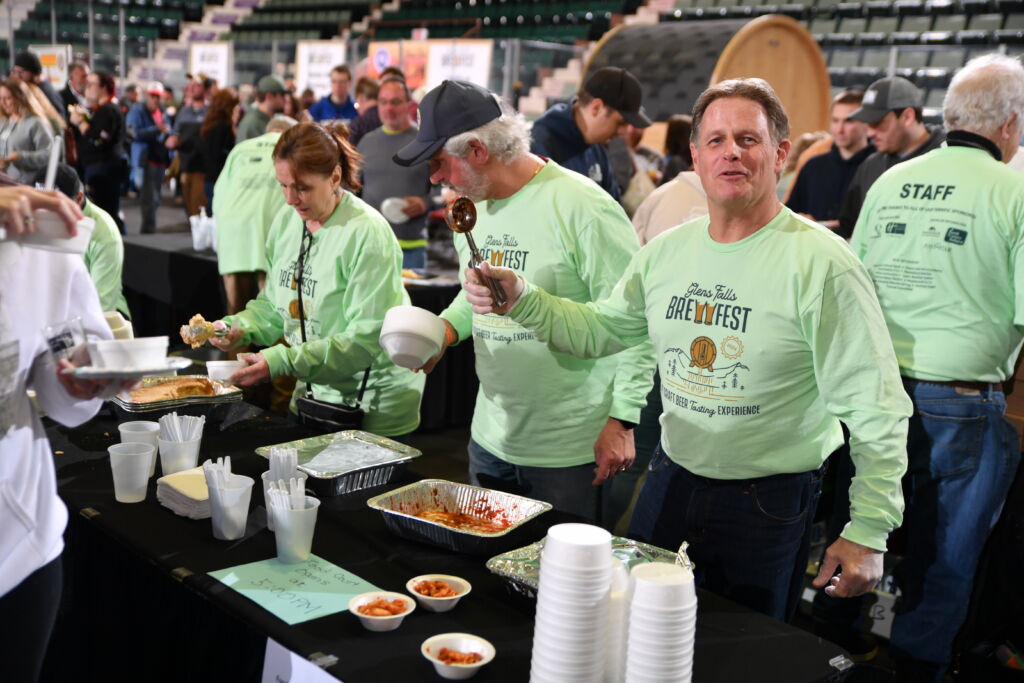 Board of Trustees President Brian Murphy (far right) serves up food at the Glens Falls Brewfest. Board of Trustees President Brian Murphy (far right) serves up food at the Glens Falls Brewfest.